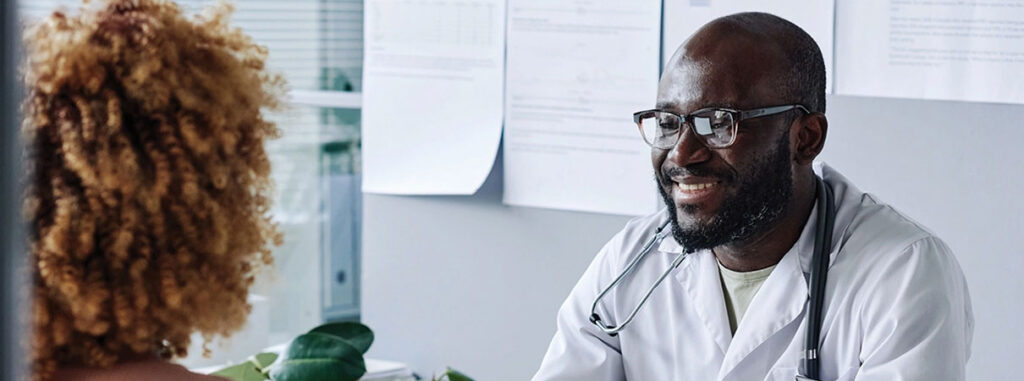 Doctor sitting at a table with patient.